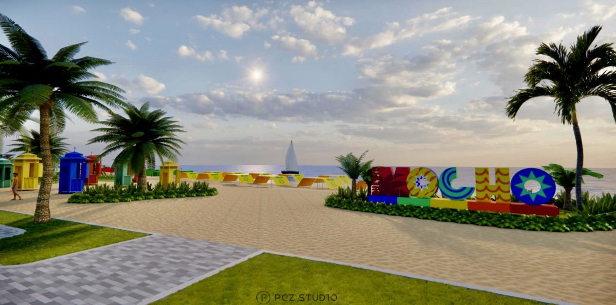 Puerto Mocho beach park in Barranquilla with palm trees and a colorful sign